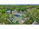 Aerial shot of well-maintained tennis courts nestled in a lush green setting, promoting active lifestyle at 4487 Glebe Farm Rd, Sarasota, FL 34235