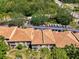 Aerial view of the condo complex surrounded by lush greenery and ample parking at 4489 Longmeadow # 74, Sarasota, FL 34235
