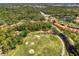 Panoramic aerial view showcasing the golf course and serene water features at 4489 Longmeadow # 74, Sarasota, FL 34235