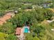 Overhead shot showcases a community pool amidst a verdant landscape, near a golf course and serene lake at 4489 Longmeadow # 74, Sarasota, FL 34235