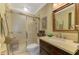 Bathroom featuring a glass-enclosed shower, vanity, and a large framed mirror at 4489 Longmeadow # 74, Sarasota, FL 34235