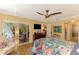 Bedroom with a ceiling fan, hardwood floors, stylish furnishings, and access to the lanai at 4489 Longmeadow # 74, Sarasota, FL 34235