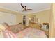Comfortable bedroom featuring two twin beds, wood floors, a ceiling fan, and closet at 4489 Longmeadow # 74, Sarasota, FL 34235
