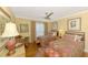 Inviting bedroom with two twin beds, wood floors, a ceiling fan, and cozy decor at 4489 Longmeadow # 74, Sarasota, FL 34235
