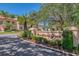 Welcome to Woodland Grove, a beautifully landscaped entrance with lush greenery and manicured signage at 4489 Longmeadow # 74, Sarasota, FL 34235