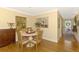Cozy dining area featuring hardwood floors with adjacent view of kitchen and hallway at 4489 Longmeadow # 74, Sarasota, FL 34235