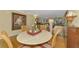 Cozy dining area with a marble table and charming decor, adjacent to the sunny living room at 4489 Longmeadow # 74, Sarasota, FL 34235