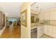 Hallway leading to the living room with a view of the kitchen and stainless steel dishwasher at 4489 Longmeadow # 74, Sarasota, FL 34235