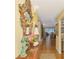 Spacious hallway with hardwood floors and an ornate mirror, leading to the living room at 4489 Longmeadow # 74, Sarasota, FL 34235