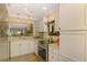 Bright kitchen with stainless steel range and passthrough to living room at 4489 Longmeadow # 74, Sarasota, FL 34235