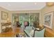 Comfortable living room with hardwood floors and access to the screened-in porch with outdoor views at 4489 Longmeadow # 74, Sarasota, FL 34235