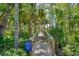 Inviting wooden path surrounded by tropical vegetation, leading to community amenities at 4489 Longmeadow # 74, Sarasota, FL 34235