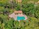 Aerial view of a private pool surrounded by lush greenery and walkways, providing a tranquil outdoor escape at 4489 Longmeadow # 74, Sarasota, FL 34235