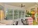 Relaxing screened porch with wicker chairs and a beautiful view of the lush backyard at 4489 Longmeadow # 74, Sarasota, FL 34235