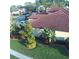 Aerial view of a single-Gathering home with a well-manicured lawn and mature landscaping at 4622 Grand Lakeside Dr, Palm Harbor, FL 34684