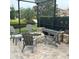 Outdoor firepit with comfortable lounge chairs within a screened enclosure for relaxing evenings at 4622 Grand Lakeside Dr, Palm Harbor, FL 34684