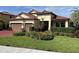 Charming single-Gathering home featuring a well-manicured lawn and beautiful landscaping at 4622 Grand Lakeside Dr, Palm Harbor, FL 34684