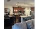 Elegant kitchen features custom wood cabinetry, stainless appliances, and a granite island at 4622 Grand Lakeside Dr, Palm Harbor, FL 34684