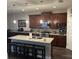 Well-appointed kitchen with dark wood cabinetry, granite countertops, and stainless steel appliances at 4622 Grand Lakeside Dr, Palm Harbor, FL 34684