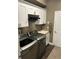 Functional laundry room with modern washer and dryer, storage cabinets, and convenient sink area at 4622 Grand Lakeside Dr, Palm Harbor, FL 34684