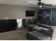 Inviting living room with a sectional sofa, entertainment center, and a ceiling fan at 4622 Grand Lakeside Dr, Palm Harbor, FL 34684