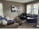 Comfortable living room features a stylish couch, leather chairs, and an area rug at 4622 Grand Lakeside Dr, Palm Harbor, FL 34684
