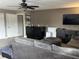 Spacious living room with comfortable seating, ceiling fan, and entertainment center at 4622 Grand Lakeside Dr, Palm Harbor, FL 34684