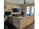Inviting living area with sectional sofa, TV, and easy access to the outdoor screened-in lanai at 4622 Grand Lakeside Dr, Palm Harbor, FL 34684