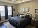 Main bedroom showcasing a comfortable bed, tray ceiling and natural light, ideal for relaxation at 4622 Grand Lakeside Dr, Palm Harbor, FL 34684