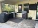 Covered patio area featuring outdoor grills on a decorative stone tile surface perfect for cooking at 4622 Grand Lakeside Dr, Palm Harbor, FL 34684