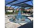 Pool area boasts submerged seating and a spa, all within a screened enclosure at 4622 Grand Lakeside Dr, Palm Harbor, FL 34684