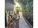 Side yard featuring a gated walkway and lush greenery surrounding the pool equipment, offering privacy at 4622 Grand Lakeside Dr, Palm Harbor, FL 34684