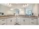 Spacious bathroom featuring double vanity sinks, white cabinets, and modern fixtures at 4725 Antrim Dr, Sarasota, FL 34240