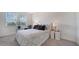 Well-lit bedroom with neutral tones, a comfortable bed, and stylish bedside tables at 4725 Antrim Dr, Sarasota, FL 34240