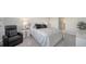 Bright bedroom featuring a plush bed, modern nightstands, and a relaxing armchair at 4725 Antrim Dr, Sarasota, FL 34240