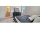 A well-lit bedroom featuring a stylish dresser, a comfortable bed, and a view to the bathroom at 4725 Antrim Dr, Sarasota, FL 34240