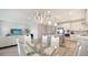 Open concept dining area with modern light fixture adjacent to kitchen and living room at 4725 Antrim Dr, Sarasota, FL 34240