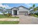 Charming home with a brick driveway, two-car garage, and lush landscaping for added curb appeal at 4725 Antrim Dr, Sarasota, FL 34240