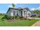Charming single-story home with a well-manicured lawn, landscaped garden, and inviting covered entrance at 4725 Antrim Dr, Sarasota, FL 34240