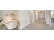Hallway with wood-look flooring and white trim leads to a dedicated desk space at 4725 Antrim Dr, Sarasota, FL 34240