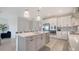 Bright, open kitchen with stainless appliances, pendant lighting, and a gray island with white quartz countertops at 4725 Antrim Dr, Sarasota, FL 34240