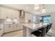 Bright modern kitchen with island featuring counter seating, stainless appliances and view to the patio at 4725 Antrim Dr, Sarasota, FL 34240