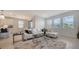 Comfortable living room with large windows, plush seating, and a view into the adjacent dining area and kitchen at 4725 Antrim Dr, Sarasota, FL 34240