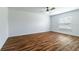 Spacious bedroom with ceiling fan, laminate floors, and a large window at 4812 Hillman Ter, North Port, FL 34288