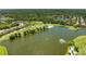 Aerial view of the lake and golf course community with lush green fairways, ponds and mature trees at 5320 Hyland Hills Ave # 2214, Sarasota, FL 34241