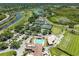 Aerial view of a community with a pool, tennis courts, golf course, and lush landscaping at 5320 Hyland Hills Ave # 2214, Sarasota, FL 34241