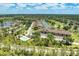 A beautiful aerial view of a condo community with golf course, lakes, and green landscape on sunny day at 5320 Hyland Hills Ave # 2214, Sarasota, FL 34241
