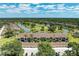 An aerial view of a condo community with lakes, golf course, and tropical landscaping on a sunny day at 5320 Hyland Hills Ave # 2214, Sarasota, FL 34241