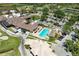 Overhead shot of a clubhouse with a pool, surrounded by a golf course and parking lot on a sunny day at 5320 Hyland Hills Ave # 2214, Sarasota, FL 34241