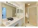 Bright bathroom with a spacious vanity, large mirror, and a walk-in shower with glass doors at 5320 Hyland Hills Ave # 2214, Sarasota, FL 34241